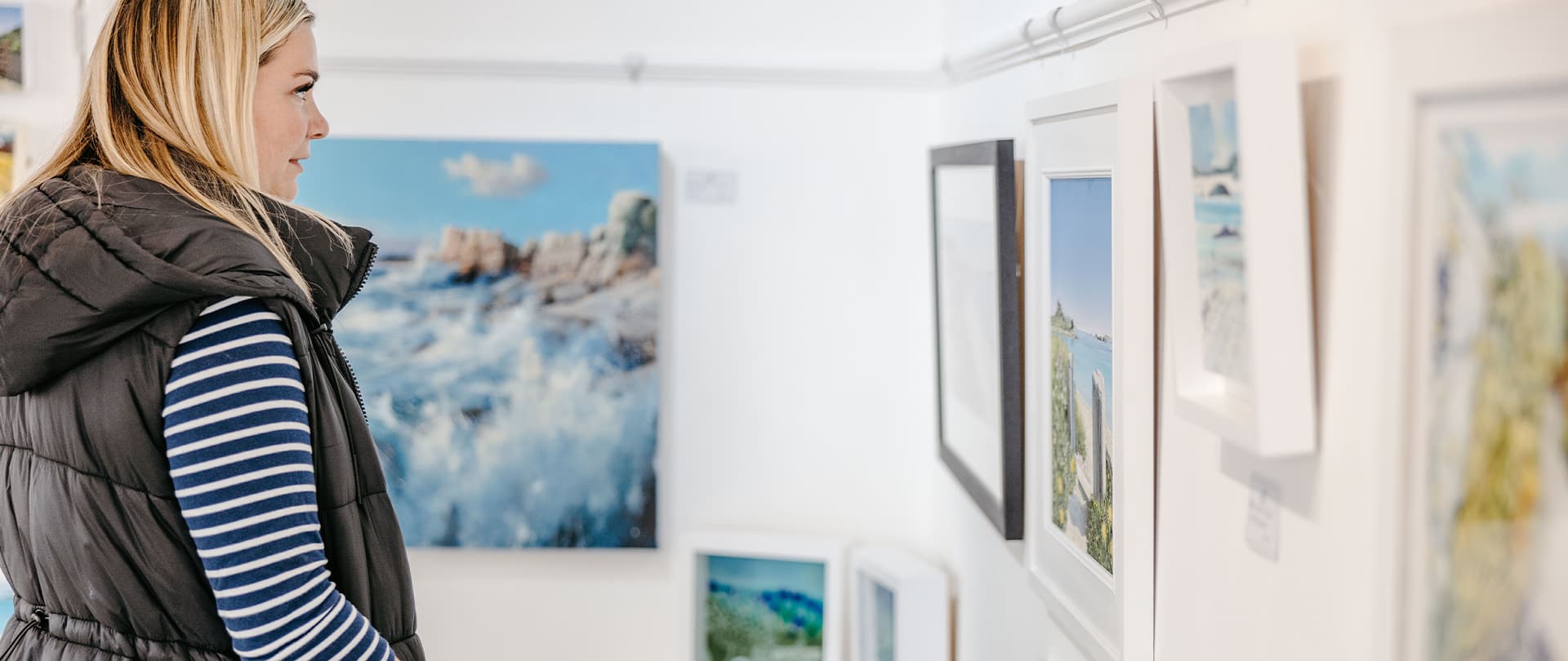 Woman walking around a gallery on St Mary's, Isles of Scilly
