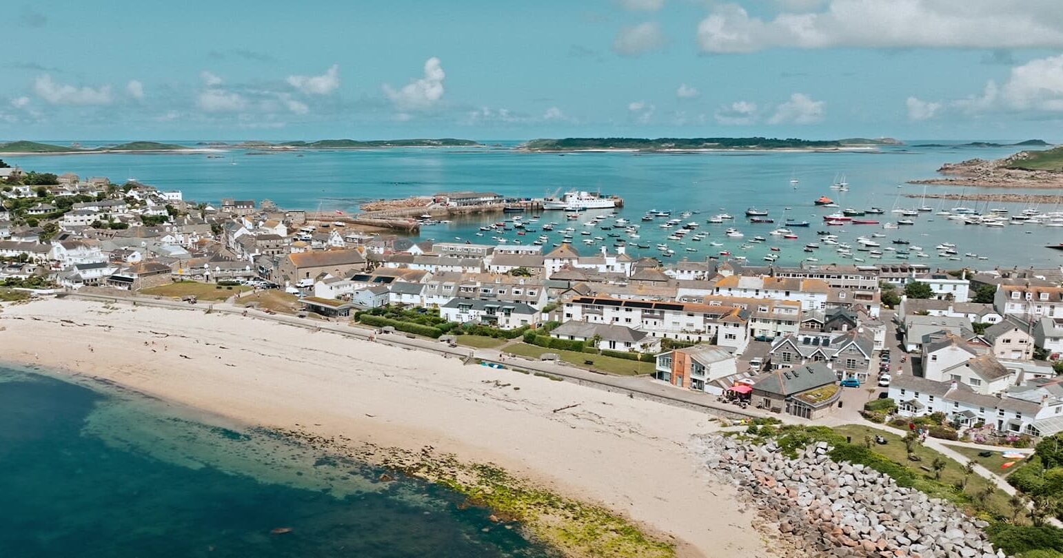 drone aerial view of Hugh Town and Scillonian III in St Mary's Harbour, Isles of Scilly