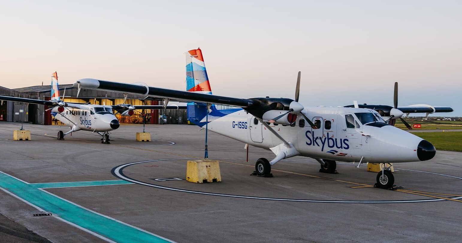 Two Skybus Twin Otter aircraft on the airfield early in the morning at Land's End Airport