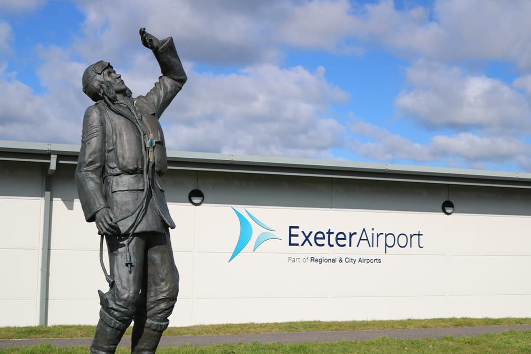 Exeter Airport sign and WWII monument
