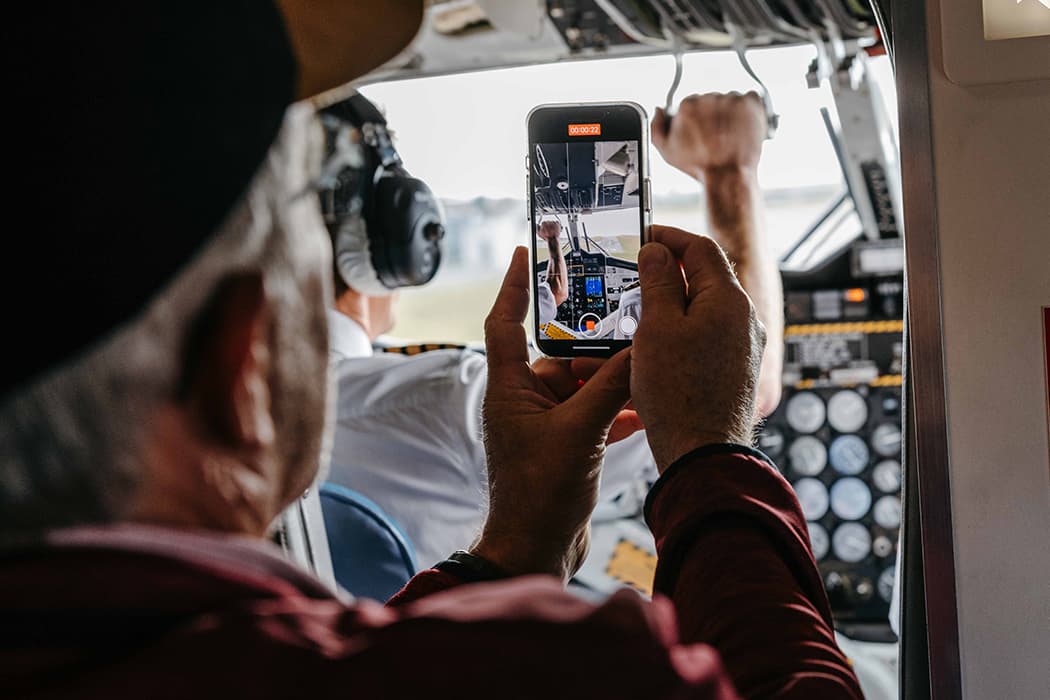 passenger taking a photo of the pilot flying a skybus aircraft