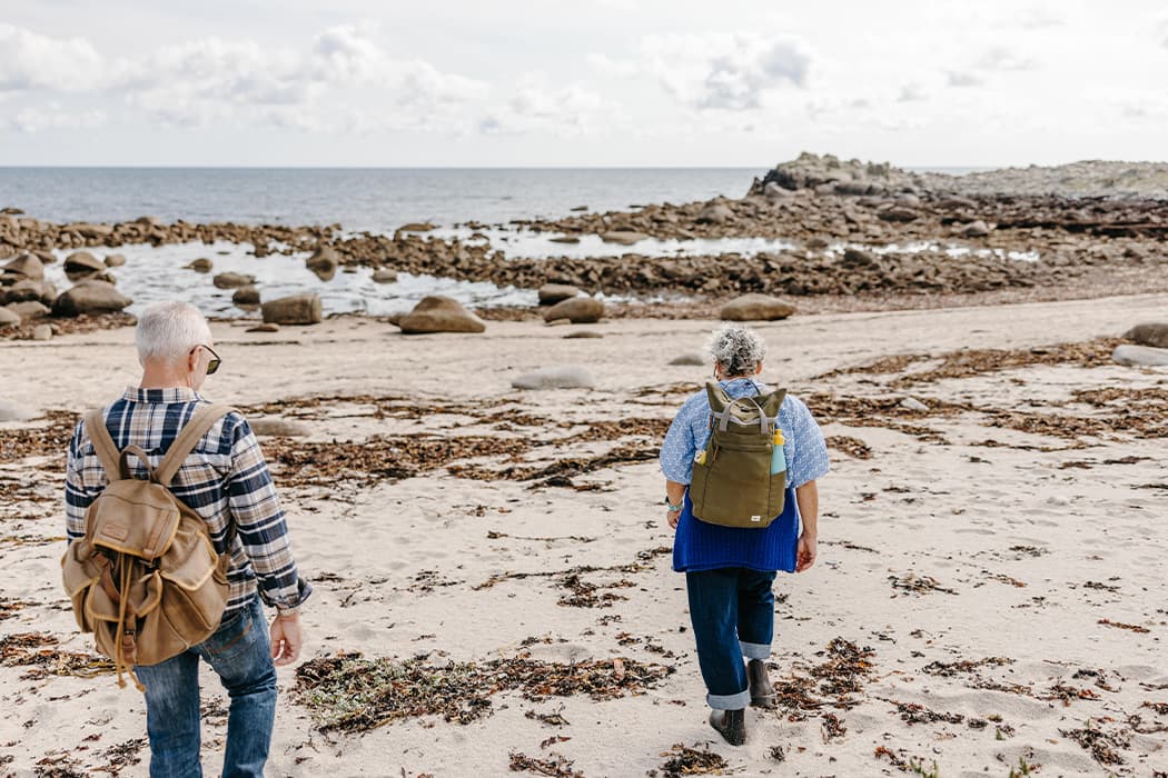 People beachcombing Beady Pool, St Agnes, Isles of Scilly