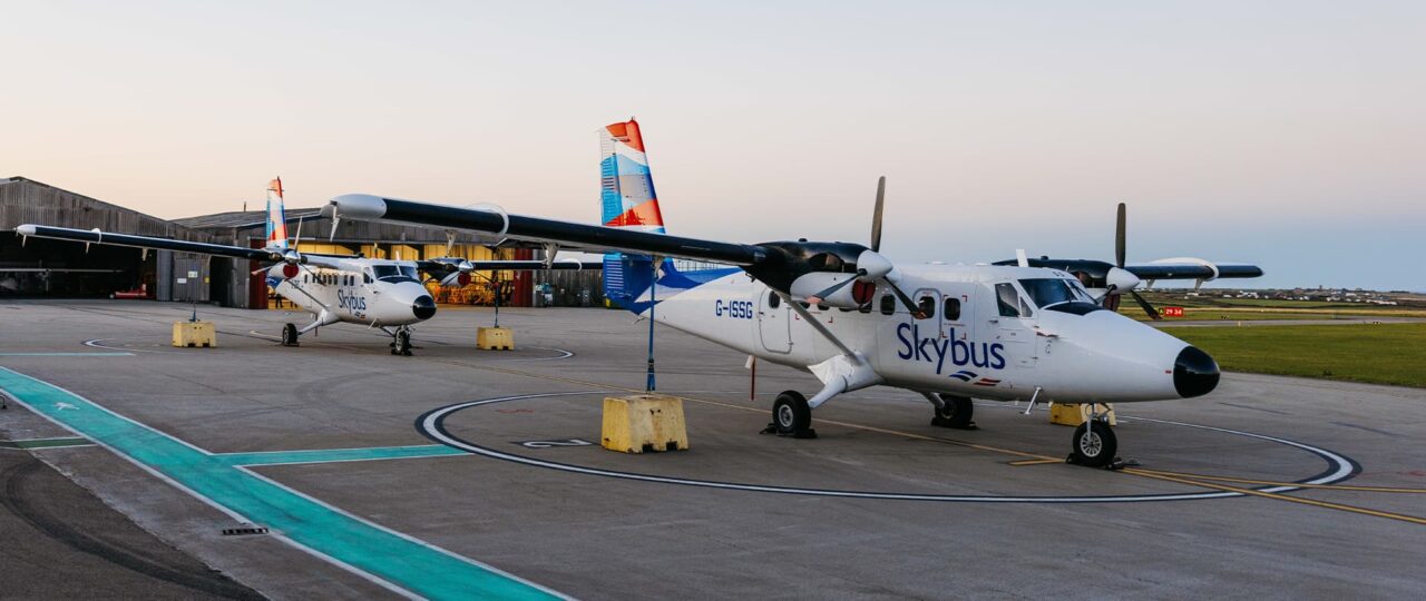 Two Skybus Twin Otter aircraft on the airfield early in the morning at Land's End Airport