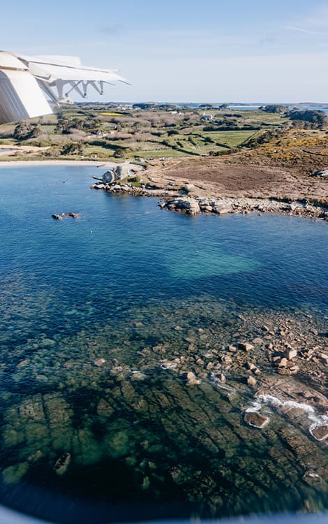 view from a Skybus aircraft window landing at St May's Airport, Isles of Scilly
