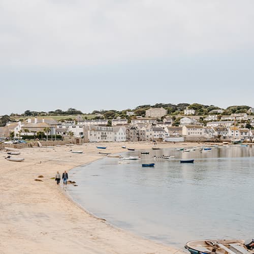 couple walking town beach, st mary's, Isles of Scilly