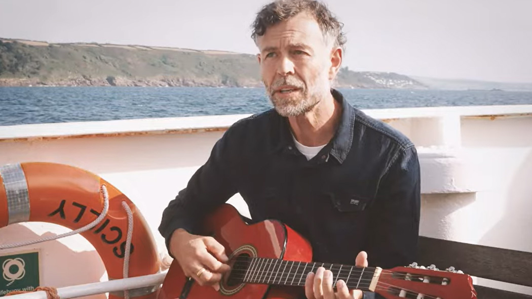 Joel Payne aboard Scillonian III playing his guitar