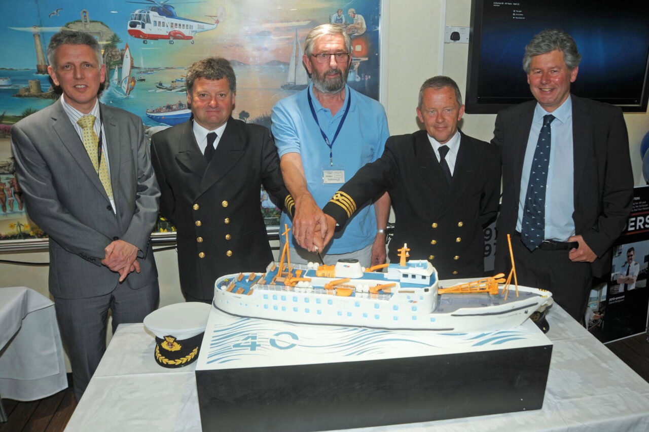 Former CEO of ISSG Rob Goldsmith; Master Dave Redgrave, former Master Paul Row, Relief Master Pete Crawford and Andrew May cutting a cake on board Scillonian III for her 40th birthday.