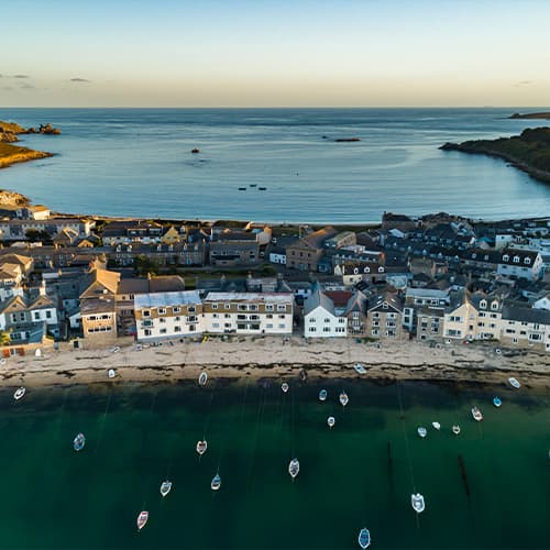 Aerial view of the habour, houses, Town and Porthcressa beaches, St Mary's