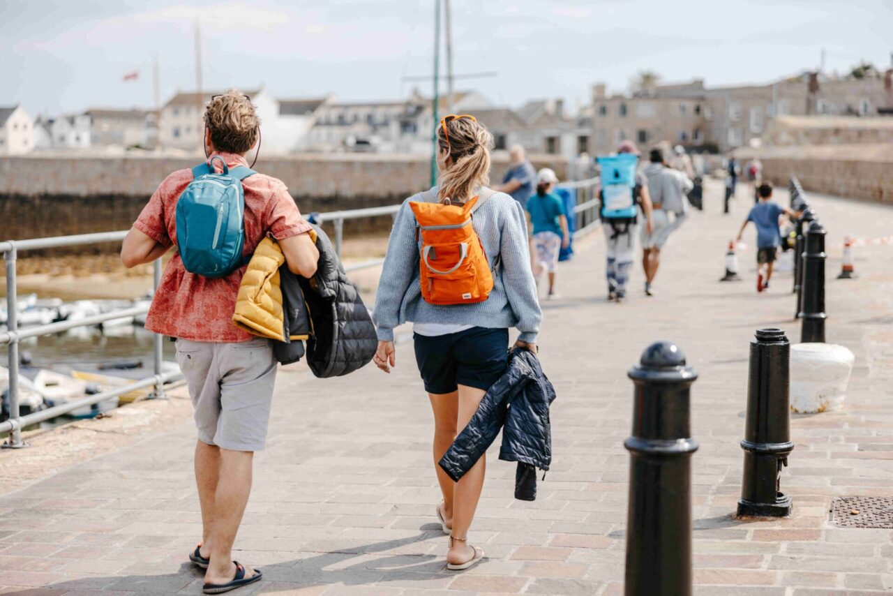 A couple walking towards Hugh Town along St Mary's Quay