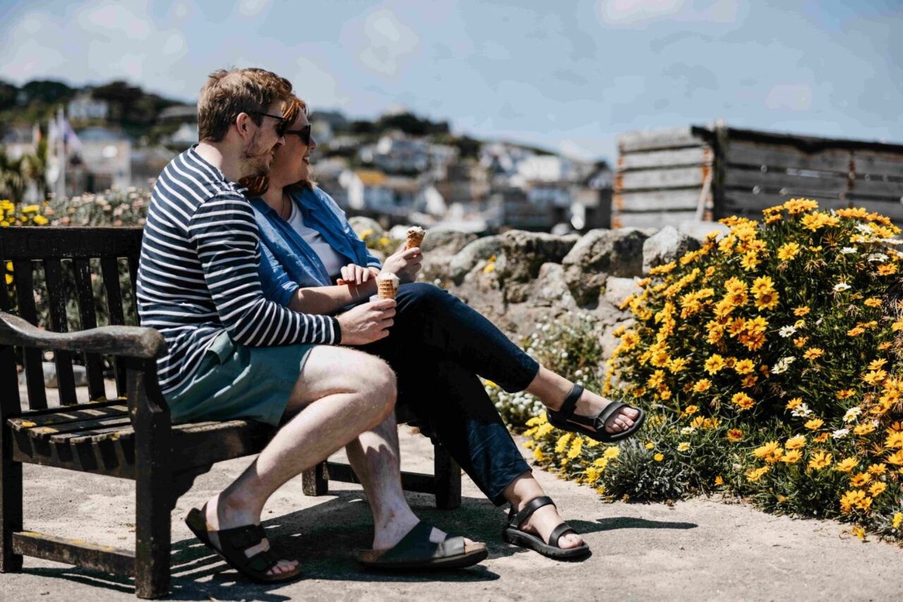 a couple eating ice cream on a bench in st mary's