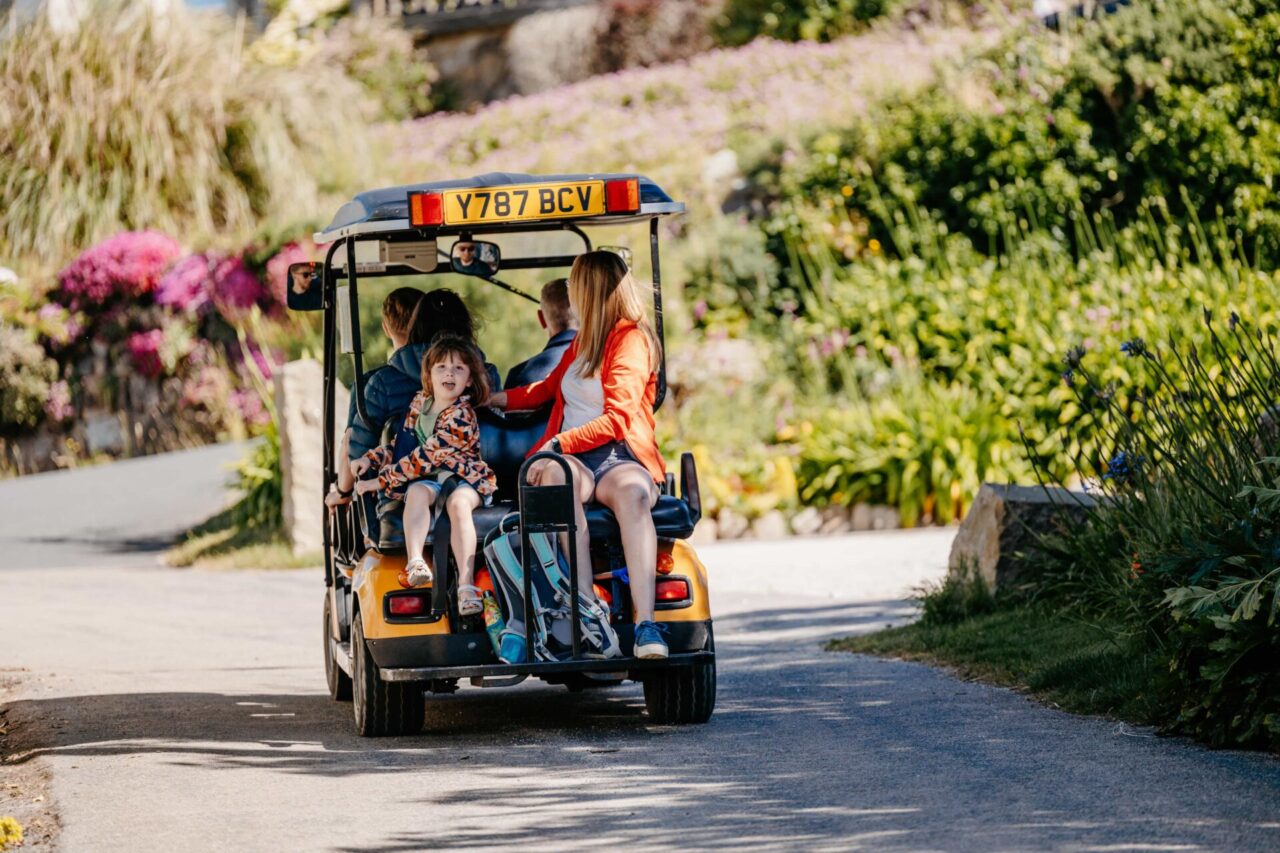 Family travelling on a Scilly cart which they have hired on St Mary's