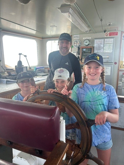 Sholto and young children in wheelhouse on Scillonian