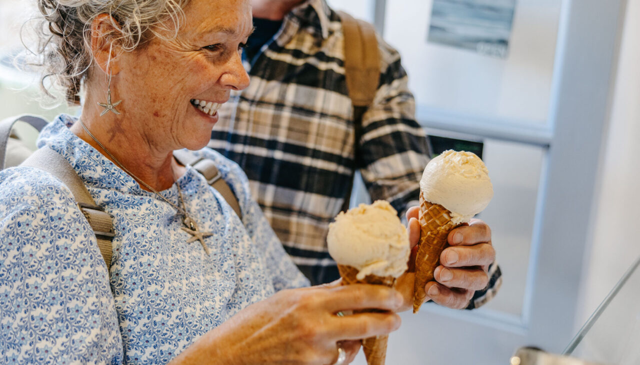 A couple enjoying ice creams from troytown farm on St Agnes, Isles of Scilly